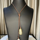 Large white Baroque Pearl with Gold Bead hang from each end of chocolate brown Leather cord. Can be worn multiple ways