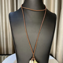 Large white Baroque Pearl with Gold Bead hang from each end of chocolate brown Leather cord. Can be worn multiple ways