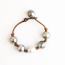Light Gray Tahitian and White South Sea Pearls knotted on Natural Leather Cord. Pearl Button Closure.