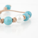 Turquoise with White South Sea Pearl knotted on Tan Leather Cord. Adjustable sliding closure.