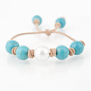 Turquoise with White South Sea Pearl knotted on Tan Leather Cord. Adjustable sliding closure.