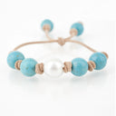 Turquoise with White South Sea Pearl knotted on Tan Leather Cord. Adjustable sliding closure.