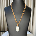 White Baroque Pearl on double strand light brown Leather cord. Pearl button closure.