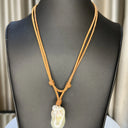 White Baroque Pearl on double strand light brown Leather cord. Pearl button closure.